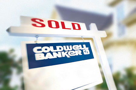 A SOLD sign with Coldwell Banker logo